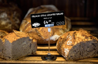 French-style country bread with a edikio bakery price tag on a wooden surface